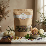 Herbes à Thé BIO – Mélange Détox Beauté loose tea blend with herbs in kraft paper pouch surrounded by flowers and leaves