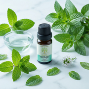 Huile Essentielle de Menthe Verte Bio – Éclat & Fraîcheur Douce with fresh green mint leaves and a small bowl of clear liquid