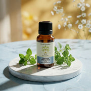 Bottle of Huile Essentielle Origan Compact BIO | Anti-infectieuse & stimulante essential oil with oregano leaves on marble plate