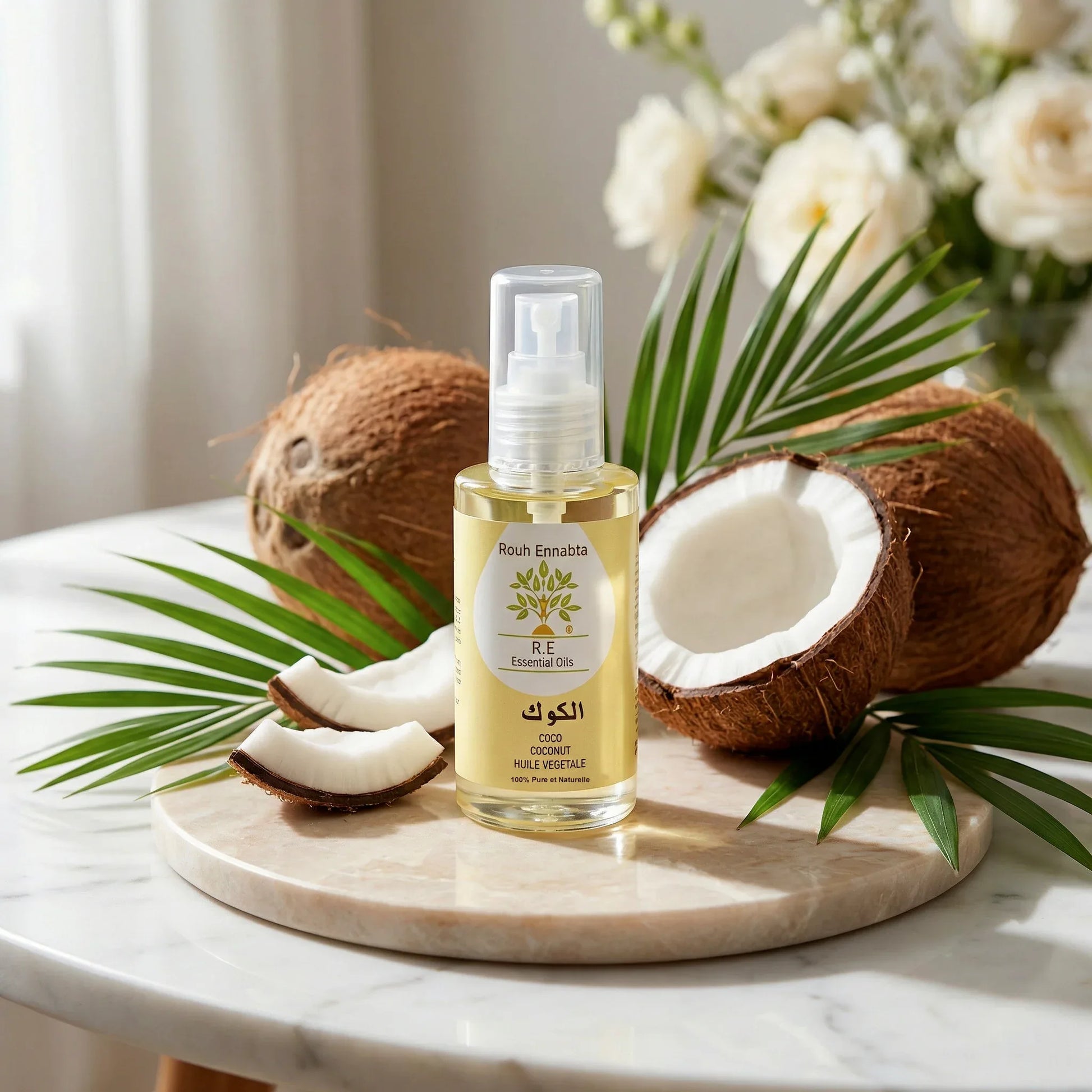 Huile de Coco BIO – Nutrition Multi-Usage bottle with fresh coconuts and palm leaves on a marble surface