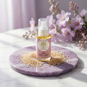 Flacon d'huile de sésame bio Jodhur entouré de graines de sésame — huile de massage ayurvédique Maroc