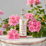 Eau Florale de Géranium BIO – Équilibrante Astringente spray bottle surrounded by pink geranium flowers on marble surface
